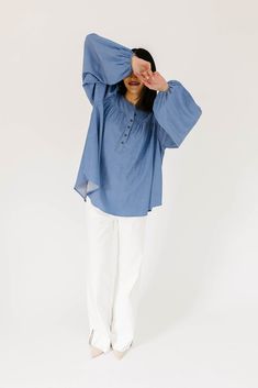 this retro-inspired long sleeve top will take you from summer picnics to fall photoshoots with ease. made with a dark wash denim-esque material, this elevated top features long balloon sleeves + a flowy silhouette. dress it up with trousers + heels, or down with white jeans + sandals. medium wash // high neckline, buttons, balloon sleeves, elastic cuffs paired with our camelot wide leg denim model is 5'8" + wearing a small measurements are approximate + taken while laying flat small : bust 42” l Spring Casual Puff Sleeve Blouse, Summer Peasant Top With Gathered Sleeves And Relaxed Fit, Fall Denim Puff Sleeve Top, Oversized Lantern Sleeve Blouse For Spring, Relaxed Fit Puff Sleeve Peasant Top For Spring, Oversized Summer Blouse With Gathered Sleeves, Spring Bishop Sleeve Blouse In Relaxed Fit, Summer Long Sleeve Denim Top, Spring Bishop Sleeve Blouse With Relaxed Fit