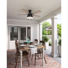 an outdoor dining area with table, chairs and ceiling fan