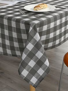 a black and white checkered table cloth with a plate of food on top of it