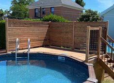 an above ground pool surrounded by wooden fence