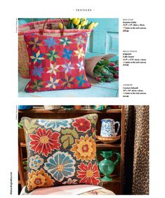 an article in the magazine features colorful pillows and vases on a table with flowers