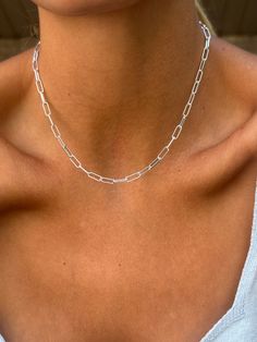 Introducing our minimalist silver paperclip link choker, designed specifically for layering. This simple chain serves as an excellent statement necklace or a versatile addition to a multi-strand set. The thick rectangle links on this decorative choker bring added dimension to your everyday stacking collection. Crafted from silver plated brass, the chain features rectangle links that are lead nickel free and hypoallergenic, ensuring both style and comfort.. Each piece is handmade by our small bus Minimalist Sterling Silver Paperclip Chain Necklace, Everyday Silver Paperclip Bracelet With Delicate Chain, Minimalist Sterling Silver Chain Necklace, Minimalist Silver Chain Necklace With Rectangular Links, Minimalist Sterling Silver Chain Necklace With Rectangular Links, Minimalist Silver Chain Necklace With Paperclip Chain, Minimalist Silver Paperclip Bracelet With Delicate Chain, Silver Delicate Chain Rectangular Necklace, Silver Rectangular Delicate Chain Necklace