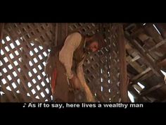 a man hanging upside down on a metal structure with words above him that read, as if to say, here lives a healthy man