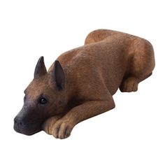 a figurine of a dog laying on its side