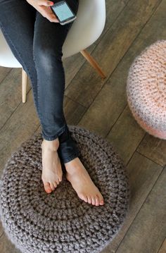 a woman sitting on top of a chair with her feet up