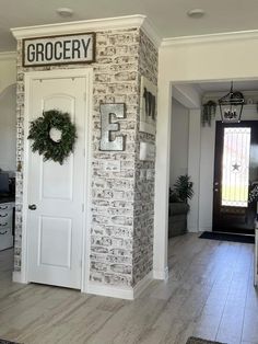 a doorway with a wreath on the door and a sign that says grocery next to it