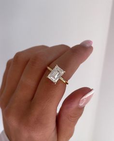 All Material Options Are In Solid Gold (Not Plated) Elongated 3.10 CT Emerald Cut Moissanite Engagement Ring, Hidden Halo Wedding Ring, Solitaire Proposal Ring, Delicate Anniversary Gifts/Ring ❤ ITEM DETAILS:- ✦ Brand: WhiteFlashJewels(WFJ) ✦ Handmade, high-quality item! ✦ Material: Solid 10K/14K/18K Gold, 950 Platinum and 925 Sterling Silver ✦ Diamonds Type: Colorless Moissanite Diamond ✦ Diamond Cut: Elongated Emerald Cut ✦ Center Diamond Weight: 3.10 CT ✦ Center Diamond Size: 7x10 MM ✦ Diamon Moissanite Engagement Ring Hidden Halo, Wedding Ring Solitaire, Engagement Ring Hidden Halo, Emerald Cut Moissanite Engagement Ring, Ring Hidden Halo, Moissanite Vs Diamond, Halo Wedding Ring, Unique Rings Vintage, Ring Rosegold