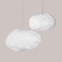 two white clouds hanging from strings on a gray background