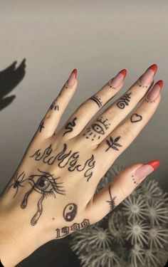 a person's hand with tattoos on it and an arrow pointing to the left