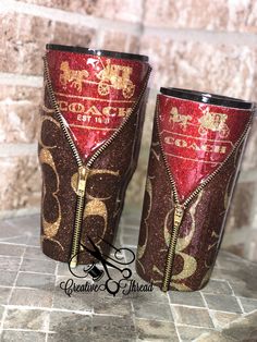 two red and gold cups with zippers on them