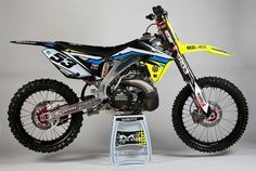 a dirt bike is shown on top of a stand