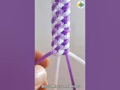 someone is holding a purple and white loom