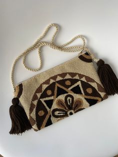 This is a handmade crochet pouch made by the Wayuu tribe from Colombia. Is one thread weaven, made with ancestral wisdom and special meaning. It looks so hippie chic and everyone will talk about it 100% COTTON directly from the Wayu' community in Guajira  Colombia, with your purchase, we help the Wayuu people to its development and evolution. Approximate dimensions: H: 5.5inch x W: 10.5inch. Straps approx. 22 Inches long Bohemian Beige Crochet Pouch Bag, Bohemian Brown Macrame Shoulder Bag, Festival Handwoven Crochet Pouch Bag, Bohemian Crochet Pouch Bag For Festivals, Brown Bohemian Crochet Bag For Festivals, Fair Trade Bohemian Beige Shoulder Bag, Bohemian Brown Crochet Shoulder Bag, Bohemian Beige Shoulder Bag Fair Trade, Bohemian Beige Fair Trade Shoulder Bag