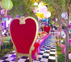 an elaborately decorated table and chairs are set up for a party