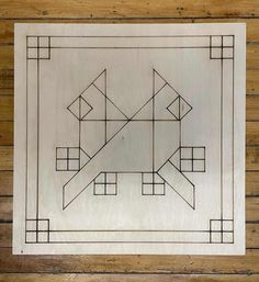 a wooden artwork with squares and rectangles on it