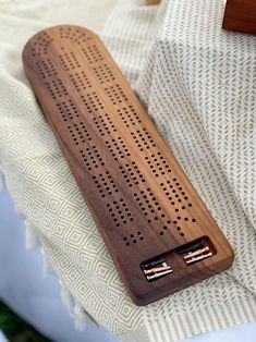 a wooden device case sitting on top of a bed