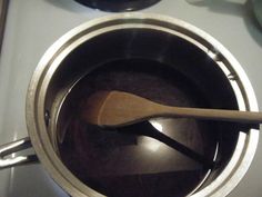 a wooden spoon in a pot on the stove