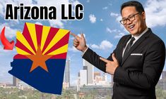 a man in a suit and tie pointing at the arizona flag with buildings in the background