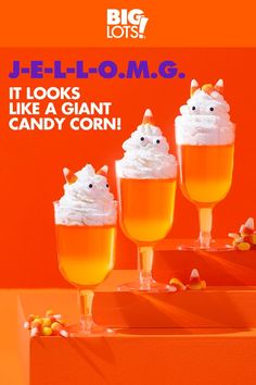 three glasses filled with ice cream and candy corn on top of an orange box that says jello - o'm g it looks like a giant candy corn