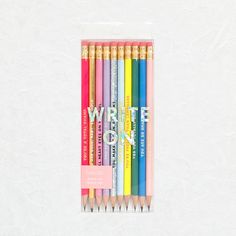 four colored pencils in a package with the words write on them and one is yellow,