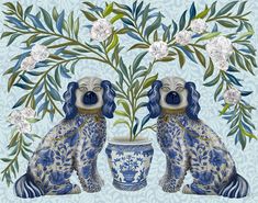 two blue and white dogs sitting next to each other near a vase with flowers on it