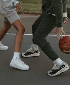 two people are playing basketball on the court