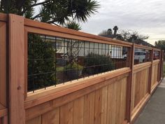 a wooden fence with metal bars on it