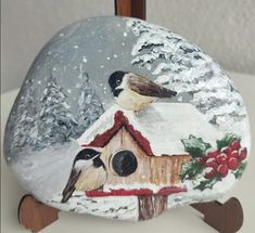 a birdhouse with two birds painted on it