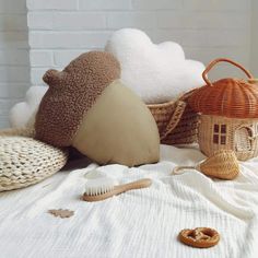 several different types of decorative items on a white bed with a brick wall in the background