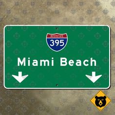 a green miami beach highway sign with an arrow pointing to the right