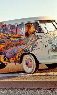 an old van painted with colorful designs on the side