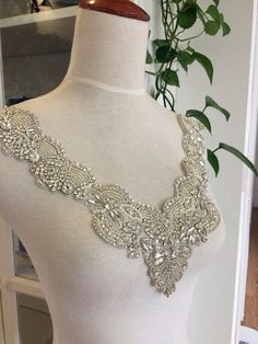 Gorgeous luxury rhinestone applique , clear crystal and pearl beaded wedding gown lace appliques, all the stones are hand sewn by silver thread which are base ground tulle ,making it more elegant and adorble . widest points: 32cm / 12.6 inches highest points: 29cm / 11.4 inches Back to shop directory https://www.etsy.com/shop/Retrolace?ref=si_shop Elegant Silver Embellished Wedding Dress, Silver Embellished Wedding Dress, Silver Lace Bridal Accessories For Wedding, Embellished Silver Wedding Dress, Wedding Gown Beaded, Luxury Wedding Gown, Beaded Wedding Gowns, Bridal Applique, Iron On Fabric