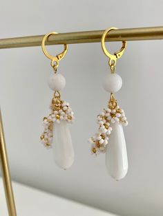 Introducing my exquisite Beaded White Jade teardrop earrings, perfect for adding a touch of elegance to any occasion. Round White Jade bead and mini beaded flowers is delicately placed to create a mesmerizing design and looks super cute. The 10x30mm natural White stone teardrop adds an extra dimension to these earrings, making them a unique and glamorous accessory. With a total lenght of 7 cm including the latch back closure, these earrings are the perfect size to make a statement without being Elegant Teardrop Crystal Earrings With Dangling Beads, White Dangle Earrings With Faceted Beads, Elegant Teardrop Earrings With Dangling Beads Gift, Delicate White Dangle Crystal Earrings, Elegant Flower Earrings With Dangling Beads, Delicate White Jewelry With Dangling Beads, Elegant Gift Teardrop Earrings With Dangling Beads, White Teardrop Beaded Earrings With Faceted Beads, White Teardrop Cluster Earrings