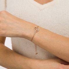 With double the love, this diamond heart bolo bracelet suits your romantic style. Created in sterling silver with 14K rose gold plate, this look features entwined sideways heart-shaped outlines - one polished, the other lined with sparkling diamonds. Captivating with 1/10 ct. t.w. of diamonds and a bright polished shine, this wheat chain bracelet adjusts up to 9.5 inches in length and secures with a bolo clasp and ball ends. Formal Rose Gold Heart Bracelets, Rose Gold Double Heart Jewelry For Formal Occasions, Formal Double Heart Rose Gold Jewelry, Adjustable Rose Gold Sterling Silver Heart Bracelet, Adjustable Rose Gold Heart Pendant Jewelry, Rose Gold Heart Bracelet In Fine Jewelry Style, Rose Gold Heart Bracelet Fine Jewelry, Dainty Rose Gold Heart Bracelet For Anniversary, Elegant Adjustable Open Heart Jewelry