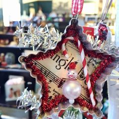 an ornament hanging from a christmas tree with music notes and candy canes