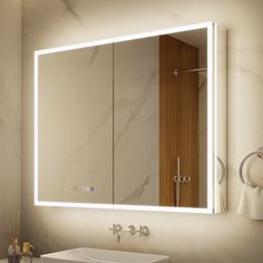 a bathroom sink sitting under a mirror next to a wall mounted faucet light