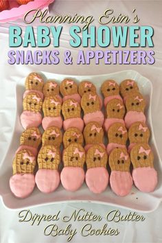 baby shower snacks and appetizers are arranged on a white platter with pink icing