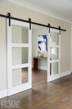 an empty room with sliding glass doors and hard wood flooring on the wooden floor