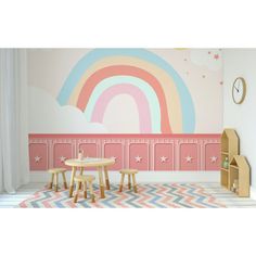 a child's room with pink walls and rainbow mural