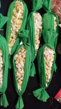 several corn cobs wrapped in green paper