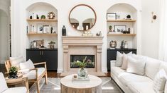 a living room filled with furniture and a fire place