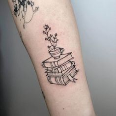 a black and white image of a stack of books with flowers on it