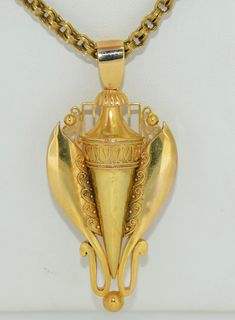 This is a rather Impressive statement piece. It is crafted from 14K Solid Gold. The pendant dates from the late 1800s. The design is very regal in my opinion. The pendant features fine Etruscan Revival gold work with smooth clean lines. The bail, I believe is a replacement but it is nicely matched. The bail pivots for a slight bit of movement. The balance is stationary. This pendant pairs fabulously with a chunky gold book chain or perhaps a nice victorian chain as photographed. The book chain i Ancient Style Gold Pendant Jewelry, Victorian Yellow Gold Jewelry With Large Pendant, Victorian 14k Gold Pendant Necklace, Luxury Ancient Style Pendant Jewelry, Etruscan Revival Jewelry, Gold Book, Gold Work, Gold Style, Solid Gold