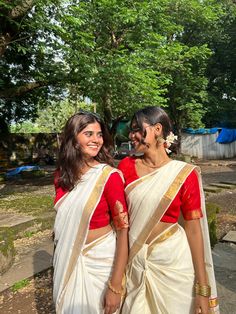 two women in sari walking down the street