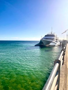 there is a boat that is in the water next to a pier with green algae