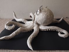 an octopus sculpture sitting on top of a black mat