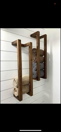 a wooden shelf that has towels on it