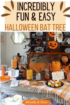 a table topped with lots of halloween treats and candy bar decorations on top of it