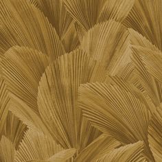 an abstract pattern made up of palm leaves in brown and gold tones on a beige background