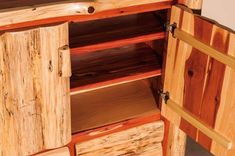 a wooden cabinet with drawers and shelves made out of wood planks on the bottom